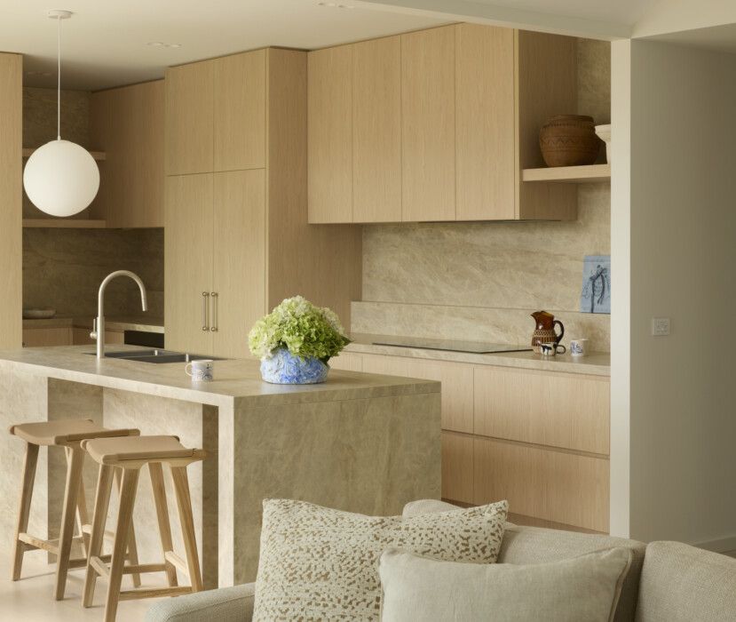 Modern kitchen with timber cabinetry, stone island bench and neutral finishes