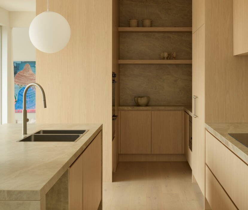 Boutique Homes modern cottage kitchen with timber cabinetry, stone island bench, pendant lighting, and walk-in pantry in a light-filled open-plan design